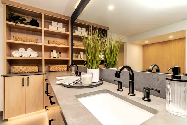 Modern on Mercer home addition on Mercer Island with a light oak vanity, open shelving, black fixtures and a lit mirror