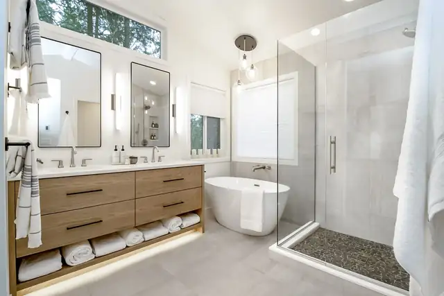 Zen Escape bathroom remodel on the Eastside with a floating oak vanity, pebble shower floor and freestanding tub
